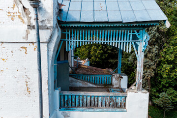 Aerial view of the second floor balcony of an old manor house from the early 20th century, wooden railings and roof. Vorobyovo, Kaluga region, Russia