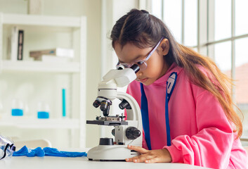 children using microscopes to study science at school - Powered by Adobe