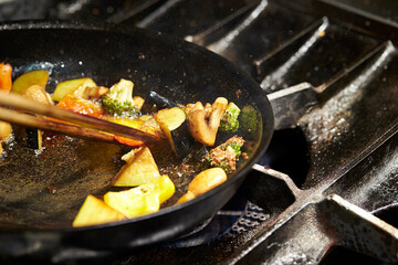 frying pan with meat and vegetables