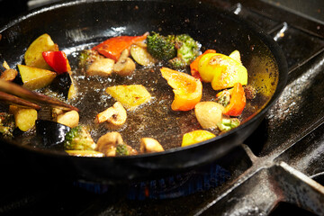 frying pan with meat and vegetables