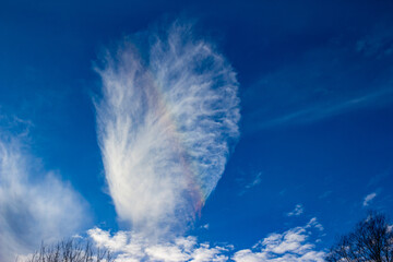 Stratus cloud with rare rainbow effect on blue sky