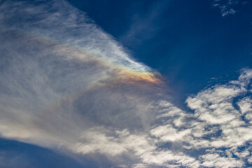 Stratus cloud with rare rainbow effect on blue sky