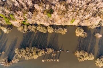 View from a drone of a river overflowing its banks during the spring flood