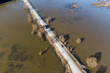 Flight over a highway passing through an area flooded during spring floods