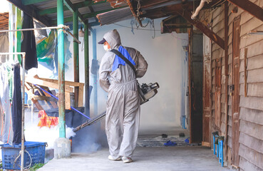 Outdoor healthcare worker using Fogging Machine Spraying chemical to Removal Mosquitoes and Control...