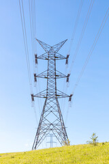 Photograph of a large telecommunications tower located on a green and grassy hill in the Blue Mountains in regional Australia