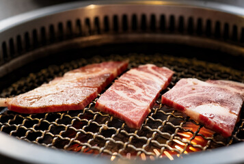 Raw beef slice on grille for barbecue or Japanese style yakiniku