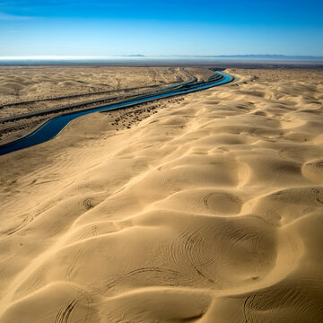 Dramatic aerial view of the all-American canal traveling through the Buttercup sand dunes in imperial county California.