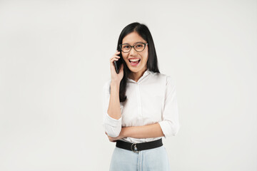 Photo of a young Asian woman smiling while talking on the phone, dressed a white shirt and isolated on a white background. 