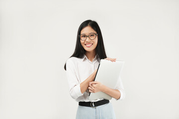 Portrait of a young Asian millennial college student holding a laptop, wearing a white shirt and glasses, isolated on a white background. Student concept.