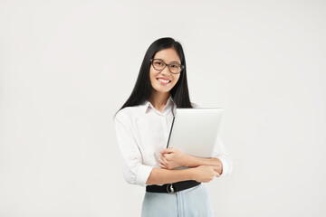 Portrait of a young Asian millennial college student holding a laptop, wearing a white shirt and glasses, isolated on a white background. Student concept.