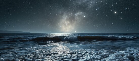 Starry skies above ocean's horizon with moon.
