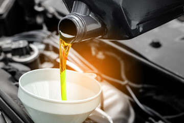 Refueling and pouring oil quality into the engine motor car Transmission and Maintenance Gear .Energy fuel concept.	
