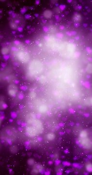 Dreamy glowing light with purple hearts loop vertical background. Concept Valentine's day animation.