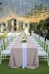 Conceptual wedding decoration. Inspirational. Dinner. Family gathering. Special moment a lifetime to remember. Long table. Table setting with arranged chairs. Flower arrangement for table.