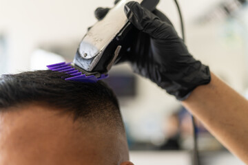 Hand of a barber using a cutting machine