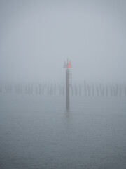 Harbor marking on foggy day