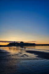 Fototapeta na wymiar sunset with a castle at the beach in isle of man