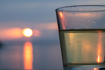 Drinking wine on balcony in luxury hotel in Fiesa with scenic view on idyllic coastline of Gulf of...
