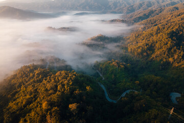 Aerial view of road in mountain valley at sunrise