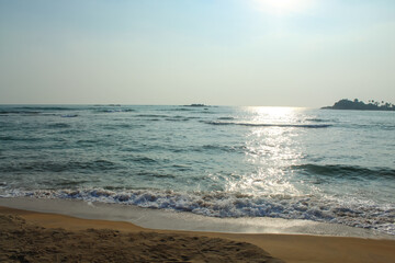 Beach with golden sand and blue ocean water on most popular Unawatuna