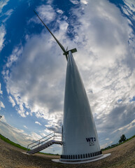 Close-up of a wind turbine producing electricity in the middle of a field and Phan captured it with...