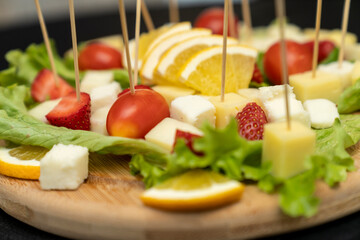 Fresh summer fruit kebab on a slate plate. vitamin sweet food background. Delicious appetizers with...