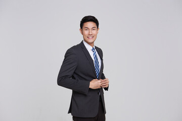 Obraz na płótnie Canvas asian business people man good looking in studio. portrait businessman in grey suit confident friendly face isolated on white background.