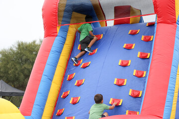 Fototapeta na wymiar A view of a children climbing an inflatable obstacle course.