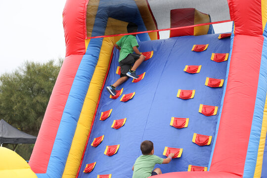 A view of a children climbing an inflatable obstacle course.