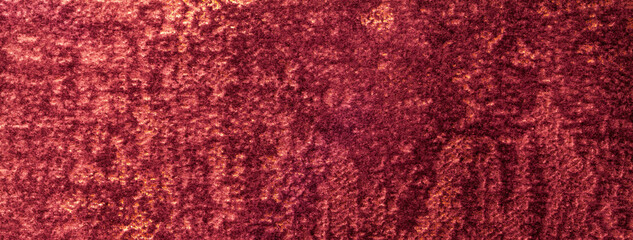 Texture of velvet dark red background from a soft upholstery textile material. Abstract velour wine fabric