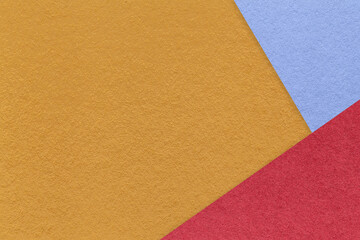Texture of craft dark yellow color paper background with blue and red border. Vintage abstract orange cardboard.