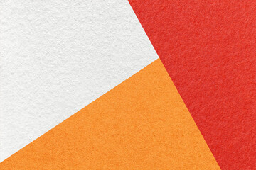 Texture of craft white, orange and red shade color paper background, macro. Vintage abstract cardboard