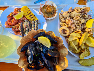 Close up view on a traditional Italian meal with grilled octopus, shrimp, scampi and fish....