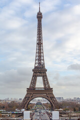 Fototapeta na wymiar Eiffel Tower seen from Trocadero viewpoint during a winter cloudy day.