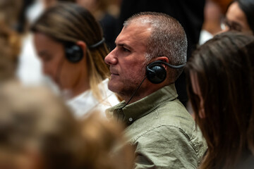 a set of headphones for simultaneous translation during negotiations in foreign languages. woman...