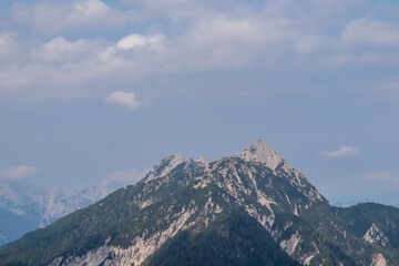 Panoramic view of mountain peak Jof di Miezegnot in untamed Julian Alps seen from hiking trail from...