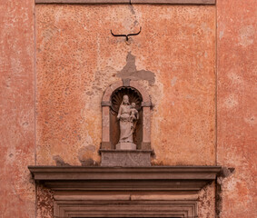 Niche with the statue of the Virgin on the facade of Chiesa di Santa Maria di Corte in old town of charming town of Cividale del Friuli, Udine province, Friuli Venezia Giulia, Italy. Sightseeing