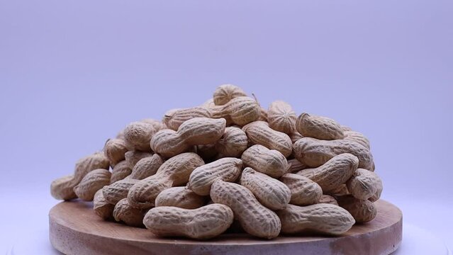 Peanuts in shell rotating on a turntable. Turning nuts.