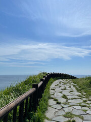 hills, fences, and the sea. a walk on a sunny hillside