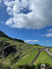Blue skies, cliffs, grass on rocks