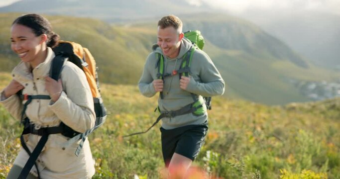 Couple of friends walking, trekking on mountain and travel for fitness, adventure or journey in nature for wellness. Young people hiking with backpack on a path or green hill for cardio and health