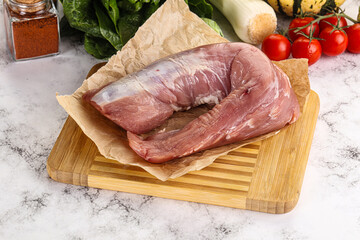Uncooked raw pork tenderloin with spices