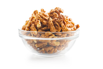 Peeled dried walnut kernels in bowl isolated on white background.