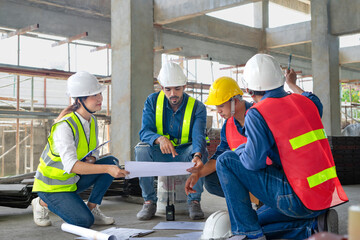 engineering or architectural work concept, engineers with coworker wearing helmet and safety vest...