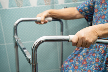 Asian elderly woman use walker in bathroom, handle security in toilet, healthy strong medical.