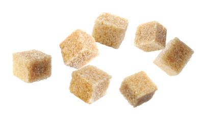Cubes of brown sugar falling on white background