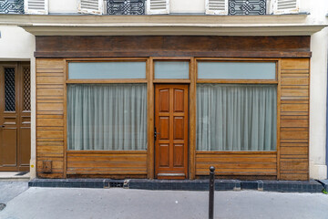 old parisian storefront facade painted in brown , commercial boutique vitrine template
