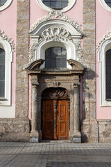 Fototapeta na wymiar Facade and portal of Hospital Church of the Holy Spirit on Maria Teresa Street, Innsbruck, Austria