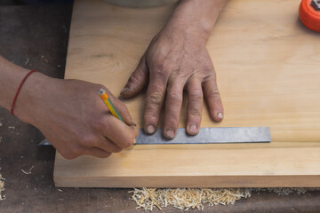 Carpenter measuring wood furniture work